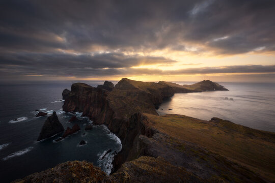 Sunset illuminates rocky coastline and ocean cliffs on Madeira Island