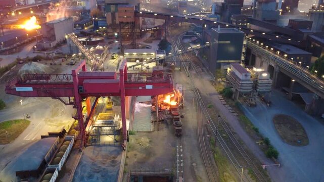 Aerial view of slag handling at a steelworks at dusk