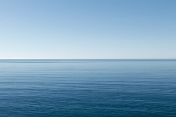 Fototapeta premium Minimalist calm blue sea horizon under soft sky