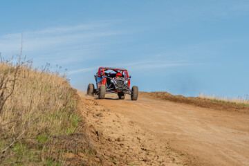 Naklejka premium Red off-road utv racing on a dirt track