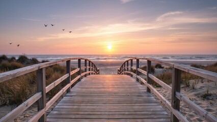 Obraz premium Wooden boardwalk leads to the sandy beach during a golden sunset with birds flying overhead. This serene coastal view inspires calm and travel themes.