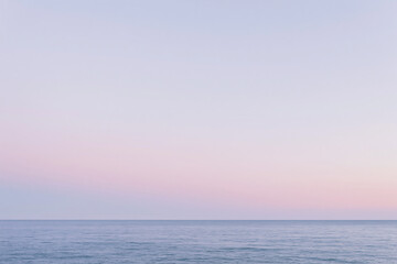 Fototapeta premium Soft Pastel Sky Over Calm Ocean Water