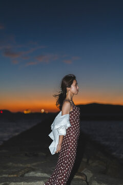 夕暮れの海にいる女性