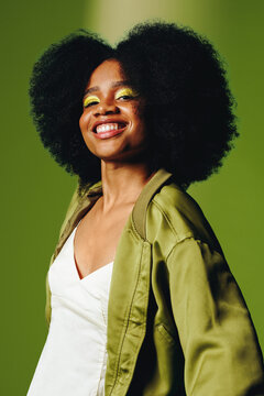 Lifestyle portrait  of a smiling woman, movement and confident identity in vibrant studio setting