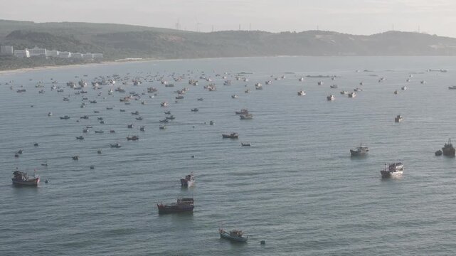 Aerial drone view of Mui Ne fishing village and Ganh Da Mui Ne coastline in Lam Dong, Vietnam, with fishing boats at sea, sandy beaches and a scenic coastal landscape.