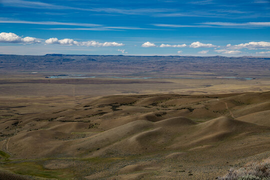 Vast icelandic volcanic landscape with distant snow capped mountain range under dramatic cloud cover patagonia