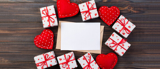 Obraz premium Envelope Mail with Red Heart and gift box over Dark Wooden Background. Valentine Day Card, Love or Wedding Greeting Concept