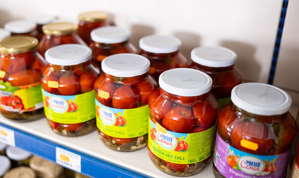 BADALONA, SPAIN - FEBRUARY 12, 2024: Russian store have traditional vegetable snack - tinned tomatoes and cuke, prepared according to various Eastern European Caucasian and Ukrainian Kherson recipes