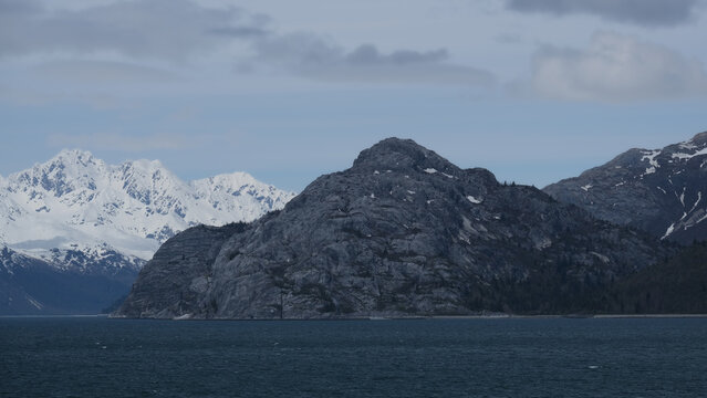 Breathtaking Alaska mountain glacier range view seen from outdoor deck of cruise ship liner sailing the Inside Passage transit with spectacular landscape wilderness scenery