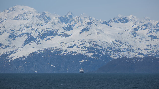 Breathtaking Alaska mountain glacier range view seen from outdoor deck of cruise ship liner sailing the Inside Passage transit with spectacular landscape wilderness scenery