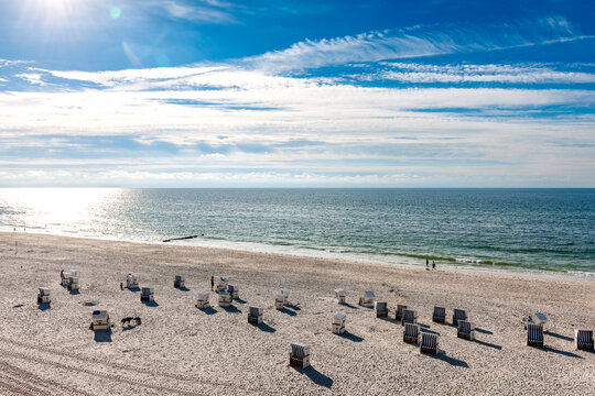 Empty beach chairs sit on the sandy beach of Sylt island