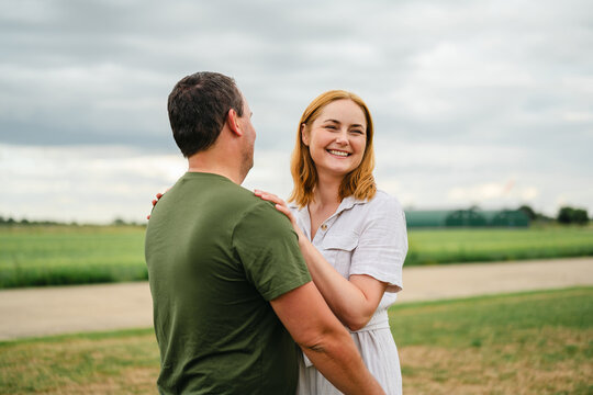 Happy mature couple embraces in the countryside