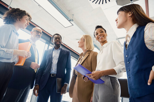 Business colleagues discuss work during a meeting in a London office