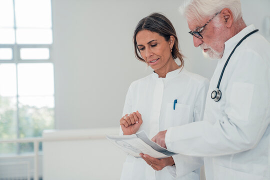 Doctors discussing medical report at hospital embracing digital medicine