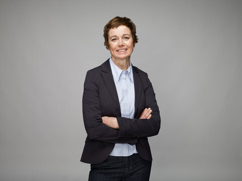 Portrait of smiling mature woman with crossed arms