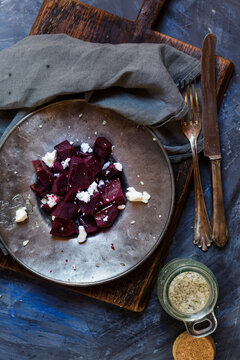 Metal plate of beetroot salad with feta and sea salt