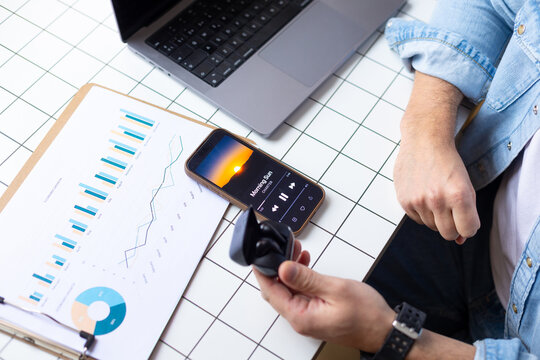 Business workspace with laptop smartphone charts and wireless earphones