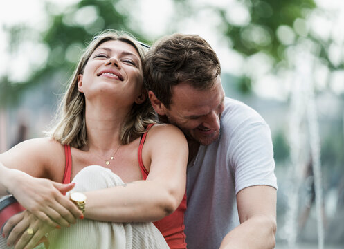 Happy man and woman share a laugh in the city