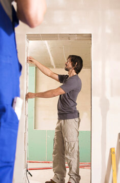 Man measuring door with folding rule