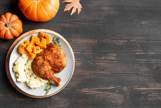 Autumn meal: chicken quarter with glazed pumpkin and mashed potato