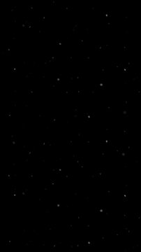 Falling particles on black background. 2d animation