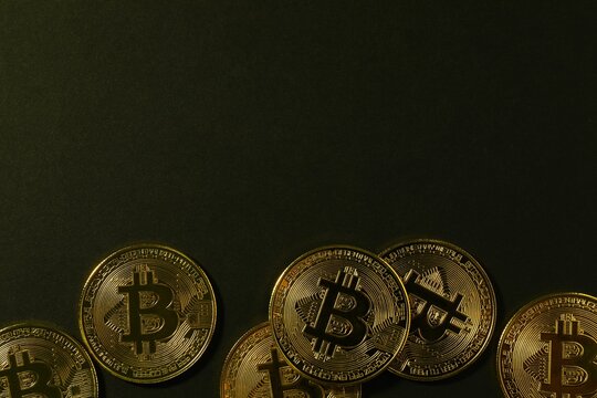 Bitcoin cryptocurrency, virtual money, blockchain technology. Golden coins on black background