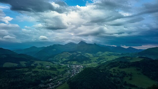 Aerial Hyperlapse Panning Over Mountain Valley Village with Dark Storm Clouds
