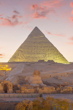 Great Sphinx and Pyramid of Khafre at dusk under artificial spotlighting on the Giza plateau