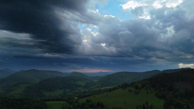 Aerial View of Storm Clouds and Rain Over Hilly Landscape