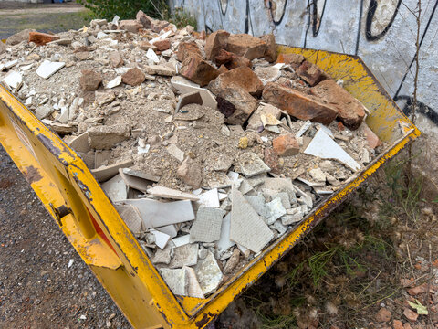 Yellow Construction Debris Skip for Recycling at a Building Site