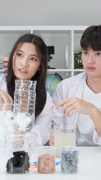 Teenage Students Conducting Water Filtration Science Experiment in Classroom Laboratory