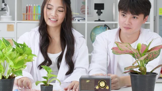 Teenage Students Conducting Biology Science Experiment with Potted Plants