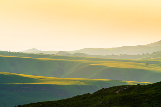 View of the green mountains and hills in the evening sunlight. Gumbashi pass in North Caucasus, Russia.