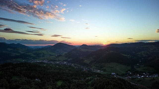 Aerial Forward Hyperlapse with Tilt Down Over Mountain Valley at Sunset