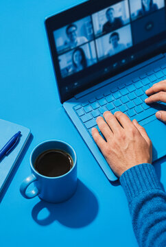 Person participating in a video conference on a laptop
