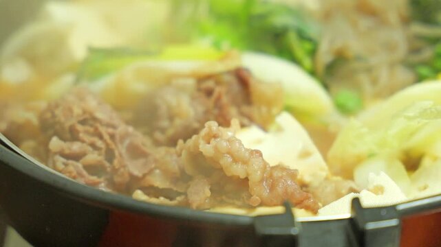 Steaming Hot Sukiyaki with Beef and Vegetables, Traditional Japanese Hot Pot Cuisine