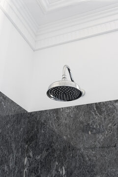 Retro style chrome rain shower head in luxury bathroom
