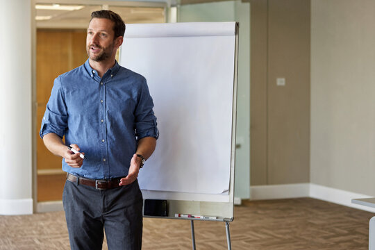 Professional Business Presenter at a Blank Flipchart