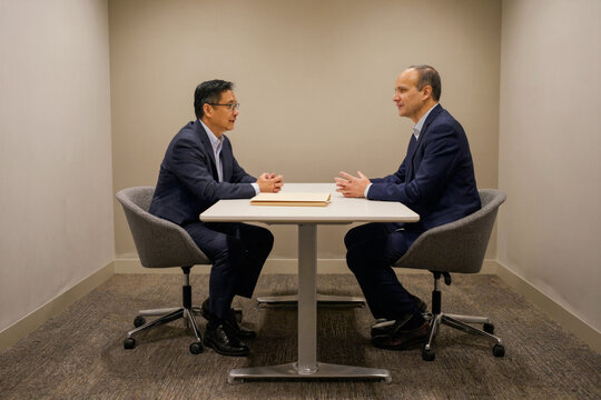 Two Business Leaders Discussing Strategy in a Private Meeting Room