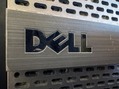 Calgary, Alberta, Canada. August 24, 2026. Extreme close-up of a metallic silver Dell logo on the brushed metal front panel of a computer.