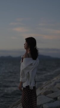 夕暮れの海にいる女性
