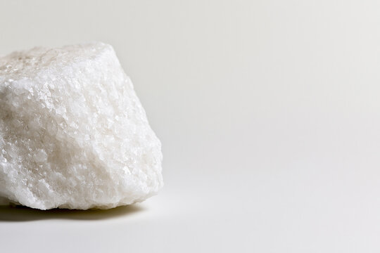 Rough block of crystalline salt with faceted texture mineral concept