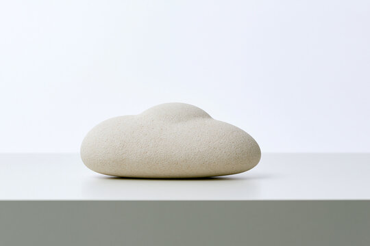 Smooth stone shaped like a soft cloud sensory surreal concept