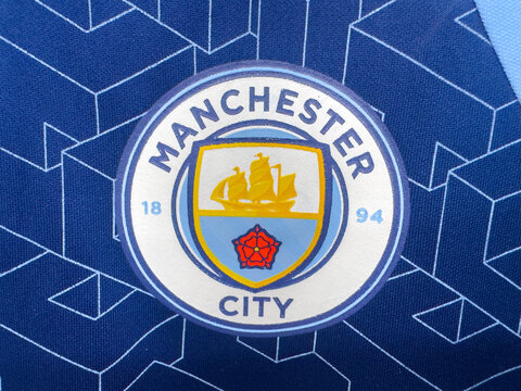 Manchester, England, UK. August 23, 2026. Macro close-up shot of the official Manchester City FC team crest embroidered on a blue jersey.