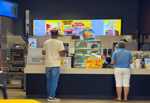 Toronto, Ontario, Canada. August 23, 2026. Wide eye-level view of customers ordering food at a McDonald's fast food restaurant counter.