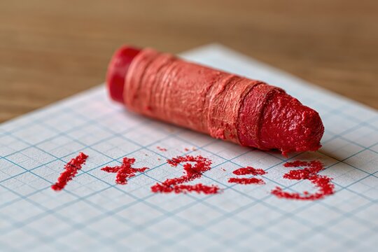 Red crayon writing simple math equation one plus two equals three