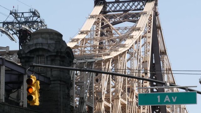 New York City Manhattan Midtown, Queensboro bridge architecture in United States. Urban transport bridge over East River. Yellow traffic light under metallic bridge in East Side. First 1st avenue sign