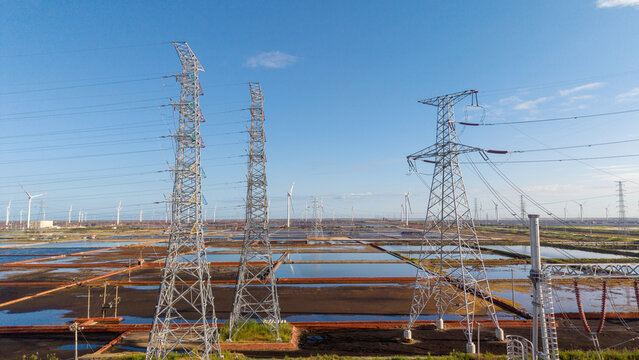 Power Transmission Towers with Wind Farms in Open Landscapes