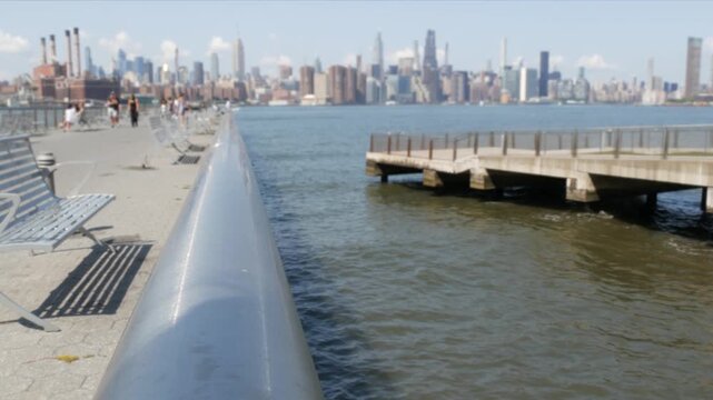 Manhattan Midtown skyline, Edge Park ferry pier promenade, North Williamsburg, New York City USA. East River waterfront, Brooklyn. Financial district skyscrapers architecture. Riverfront cityscape.