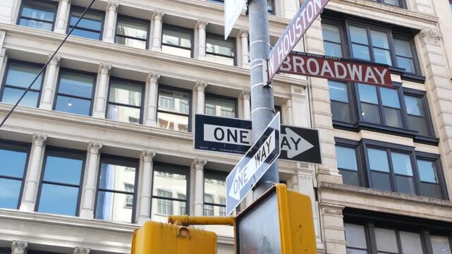 New York City Broadway street sign in Lower Manhattan, United States. Urban road sign in american city. Traffic sign in NYC USA. Building architecture in West Village district near Soho. One way arrow